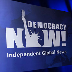 Photo of Democracy Now! logo. 
