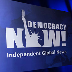 Democracy Now sign. Links to Gifts by Will