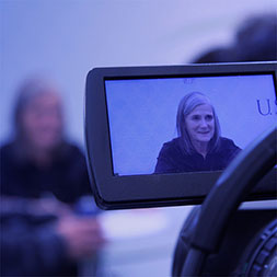 A camera filming Amy Goodman. Links to Gifts of Appreciated Securities